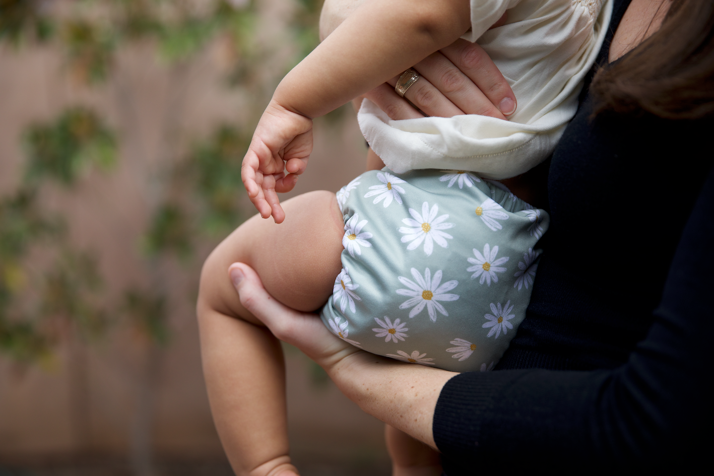 woman holding baby wearing a cloth nappy
